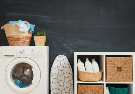 Interior of a real laundry room with a washing machine at homeの写真素材