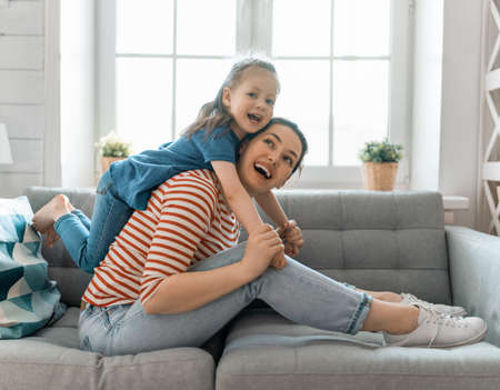 Happy mother's day! Mom and her daughter child girl are playing, smiling and hugging. Family holiday and togetherness.      の写真素材