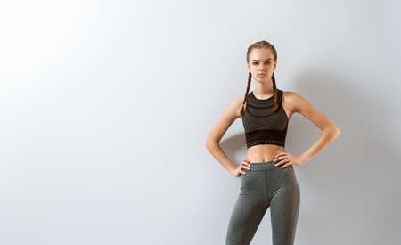 Woman in fashionable sportswear is doing exercise.