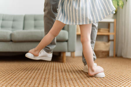 Happy father's day! Dad and his daughter child girl are dancing. Family holiday and togetherness.の写真素材