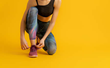 Healthy lifestyle and sport concepts. Woman in fashionable sportswear is doing exercise.の写真素材