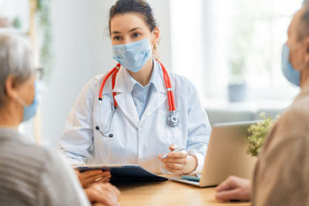 Doctor and senior couple wearing facemasks during coronavirus and flu outbreak. Virus protection,...