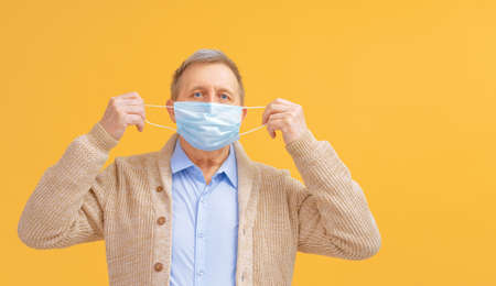 Old man wearing facemask during coronavirus and flu outbreak. Virus and illness protection, home...