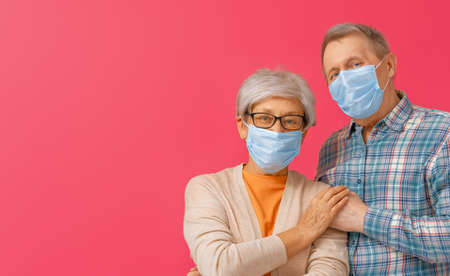 Senior couple wearing facemask during coronavirus and flu outbreak. Virus and illness protection,...