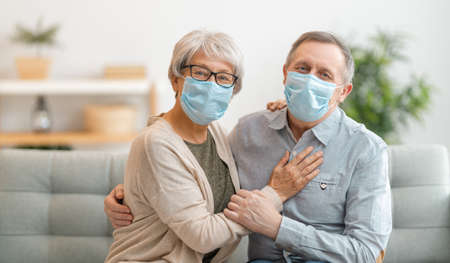 Senior couple wearing facemasks during coronavirus and flu outbreak. Virus and illness protection,...