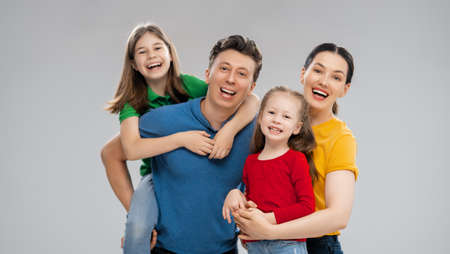 Happy loving family. Mother, father and children daughters on white background.の写真素材