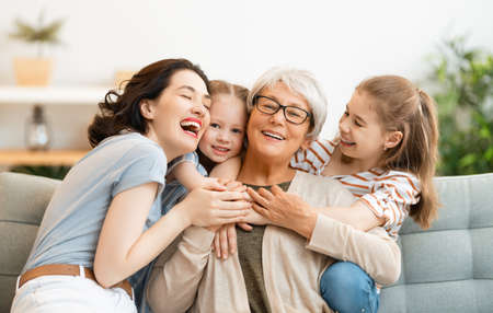 A nice girls, their mother and grandmother enjoying spending time together at home.