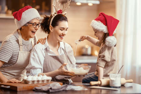 Merry Christmas and Happy Holidays. Family preparation holiday food. Grandma, mother and daughter...