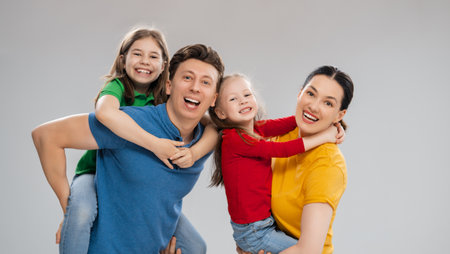 Happy loving family. Mother, father and children daughters on white background.の写真素材