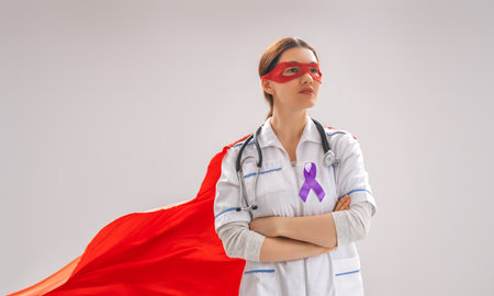 February 4 World Cancer Day. Female superhero doctor on grey wall background. Raising knowledge on people living with tumor illness.の写真素材