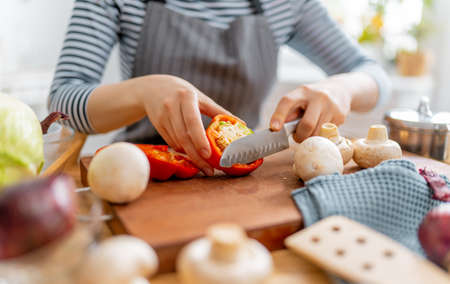 Healthy food at home. Woman is preparing the proper meal in the kitchen.の写真素材