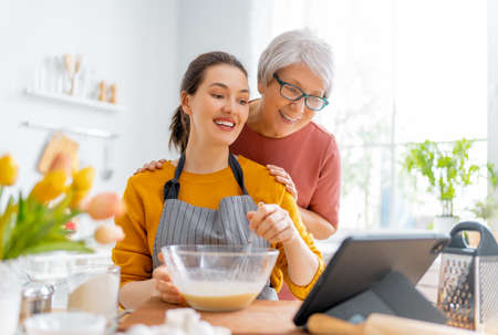 Healthy food at home. Happy women are preparing pastry in the kitchen.