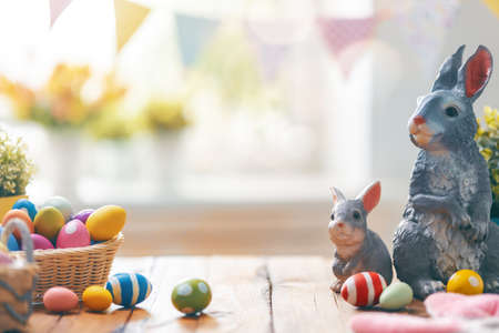 Happy Easter! Background with colorful Easter eggs in basket. Table decorating for holiday.