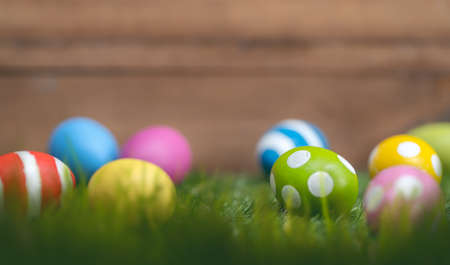 Happy Easter! Background with colorful eggs on the grass.