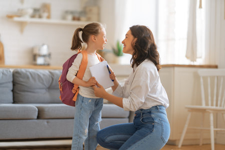 Happy family preparing for school. Little girl with mother.の写真素材
