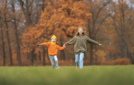 Happy family on autumn walk! Kids walking in the Park and enjoying the beautiful nature.の写真素材