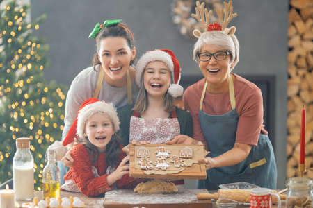 Merry Christmas and Happy Holidays. Family preparation holiday food. Grandma, mother and daughters...