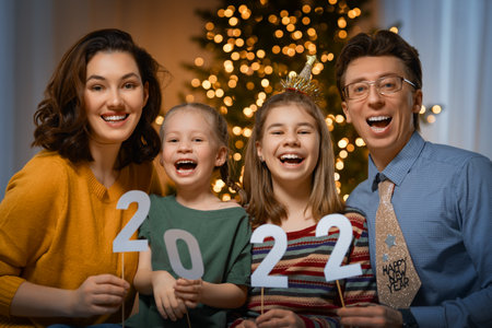 Happy family celebrating New Year at home. Mother, father and children.の写真素材