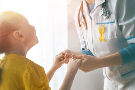 World Childhood cancer Day. Girl patient listening to a doctor in medical office.