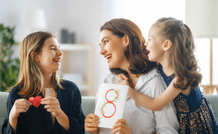 Happy International Women's Day! Children daughters are congratulating mother and giving her...