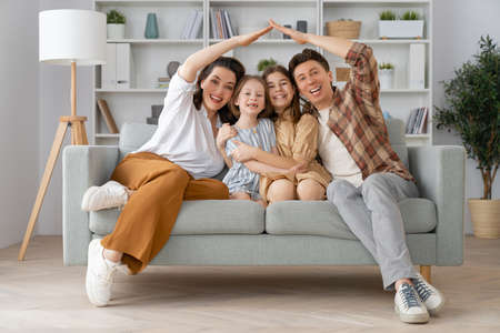 Happy family! Two children daughters with mother and father. Mum, dad and girls laughing and hugging.の写真素材