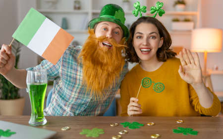 Happy family couple celebrating St. Patrick's Day.