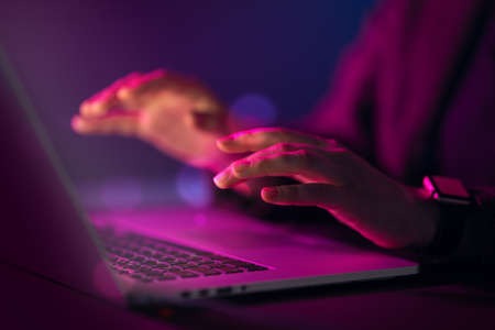 Female manager is using laptop. Computer and hands close up.