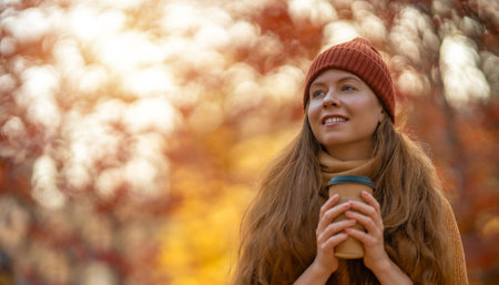 Happy fall, healthy autumn. Outdoor lifestyle portrait of young beautiful lady. Woman is walking in the park.の写真素材