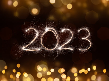 2023 New Year festive fireworks lights on dark background.