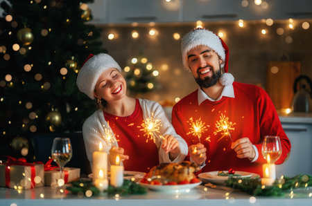 Merry Christmas. Happy loving couple is having dinner at home. Celebration holiday and togetherness near tree.の写真素材