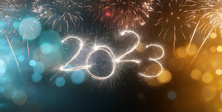 2023 New Year festive fireworks lights on dark background.