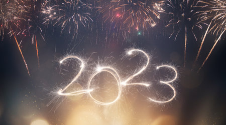 2023 New Year festive fireworks lights on dark background.
