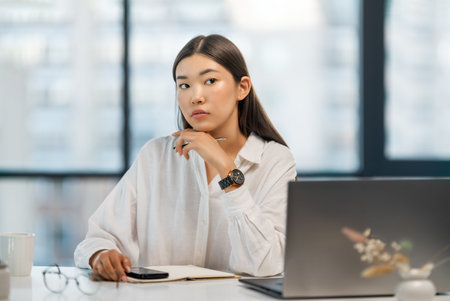 Young business lady working on laptop in office, Asian beautiful businesswoman in formal suit work in workplace.の写真素材