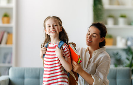 Happy family preparing for school. Little girl with mother.の写真素材