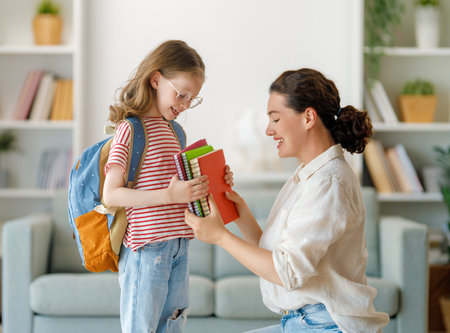 Happy family preparing for school. Little girl with mother.の写真素材