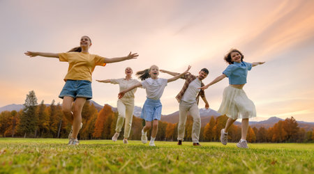 Happy family at sunset. Father, mother and children are running, having fun and enjoying summer evening.の写真素材