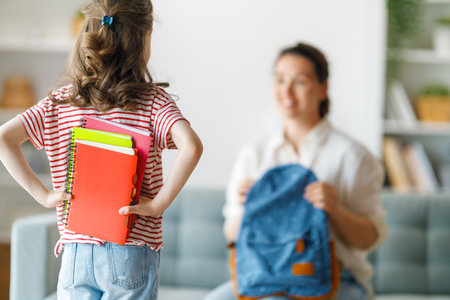 Happy family preparing for school. Little girl with mother.の写真素材