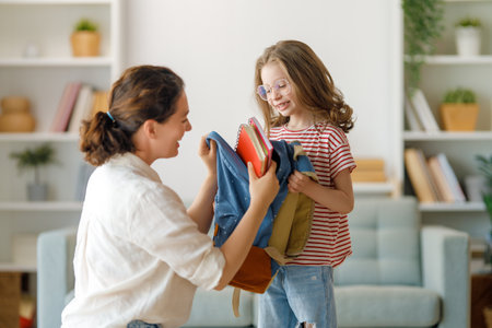 Happy family preparing for school. Little girl with mother.の写真素材