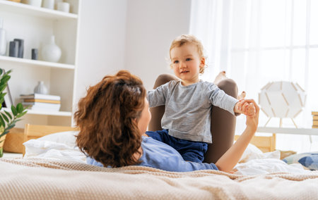 Love of mother and baby. Happy family in the bedroom at home.の写真素材