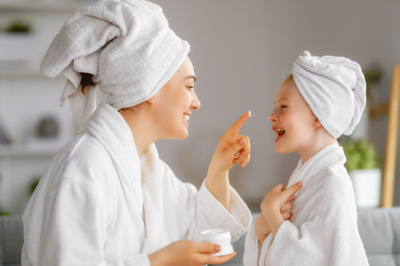 Happy family. Mother and daughter child girl are having fun after a bath.の写真素材