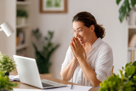 Happy casual beautiful woman working on a laptop in the office.の写真素材