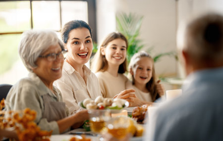 Thanksgiving Day, Autumn feast. Happy family sitting at the table and celebrating holiday....