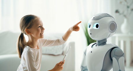 A cute girl is playing with a robot. The concept of future training.の写真素材