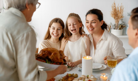 Thanksgiving Day, Autumn feast. Happy family sitting at the table and celebrating holiday....