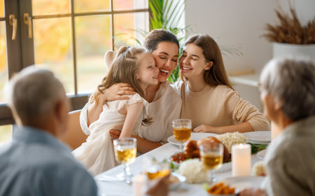 Thanksgiving Day, Autumn feast. Happy family sitting at the table and celebrating holiday. Grandparents, mother and children. Traditional dinner.の写真素材