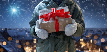 Merry Christmas. Cute little child with present against star sky. Happy kid enjoy the holiday.の写真素材