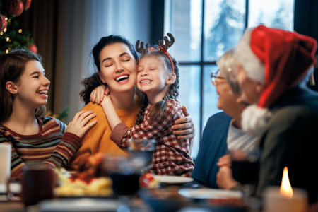 Merry Christmas! Happy family are having dinner at home. Celebration holiday and togetherness near tree.の写真素材