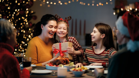 Merry Christmas! Happy family are having dinner at home. Celebration holiday and togetherness near tree.の写真素材