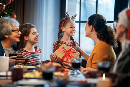 Merry Christmas! Happy family are having dinner at home. Celebration holiday and togetherness near tree.の写真素材