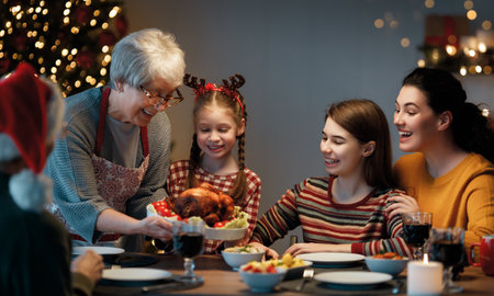 Merry Christmas! Happy family are having dinner at home. Celebration holiday and togetherness near tree.の写真素材
